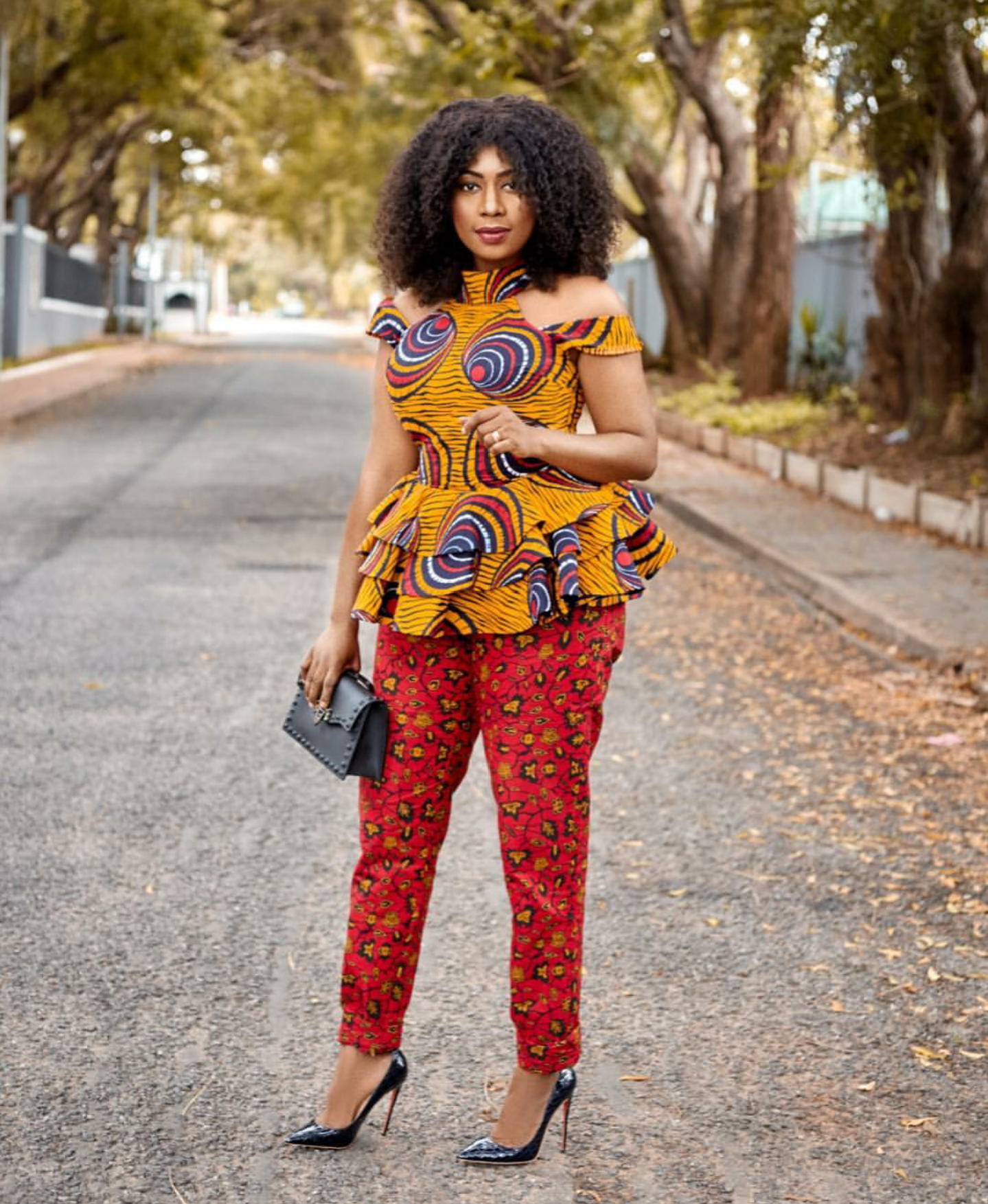 Selly Galley serving African print style goals in an off-shoulder turtle neck raffle top and pants
