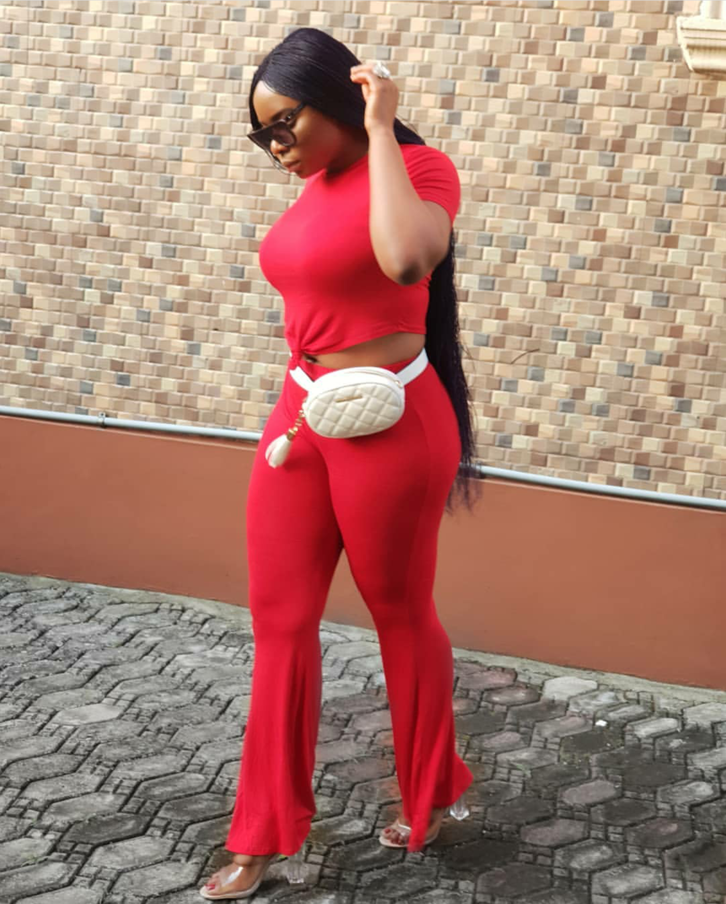 Yemi Alade was a whole slay in this two-piece flared pant and top with her fanny pack