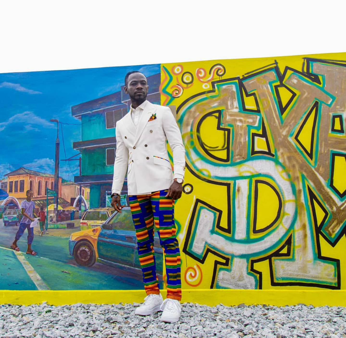 Okyeame Kwame rocking made in Ghana suit over kente pants