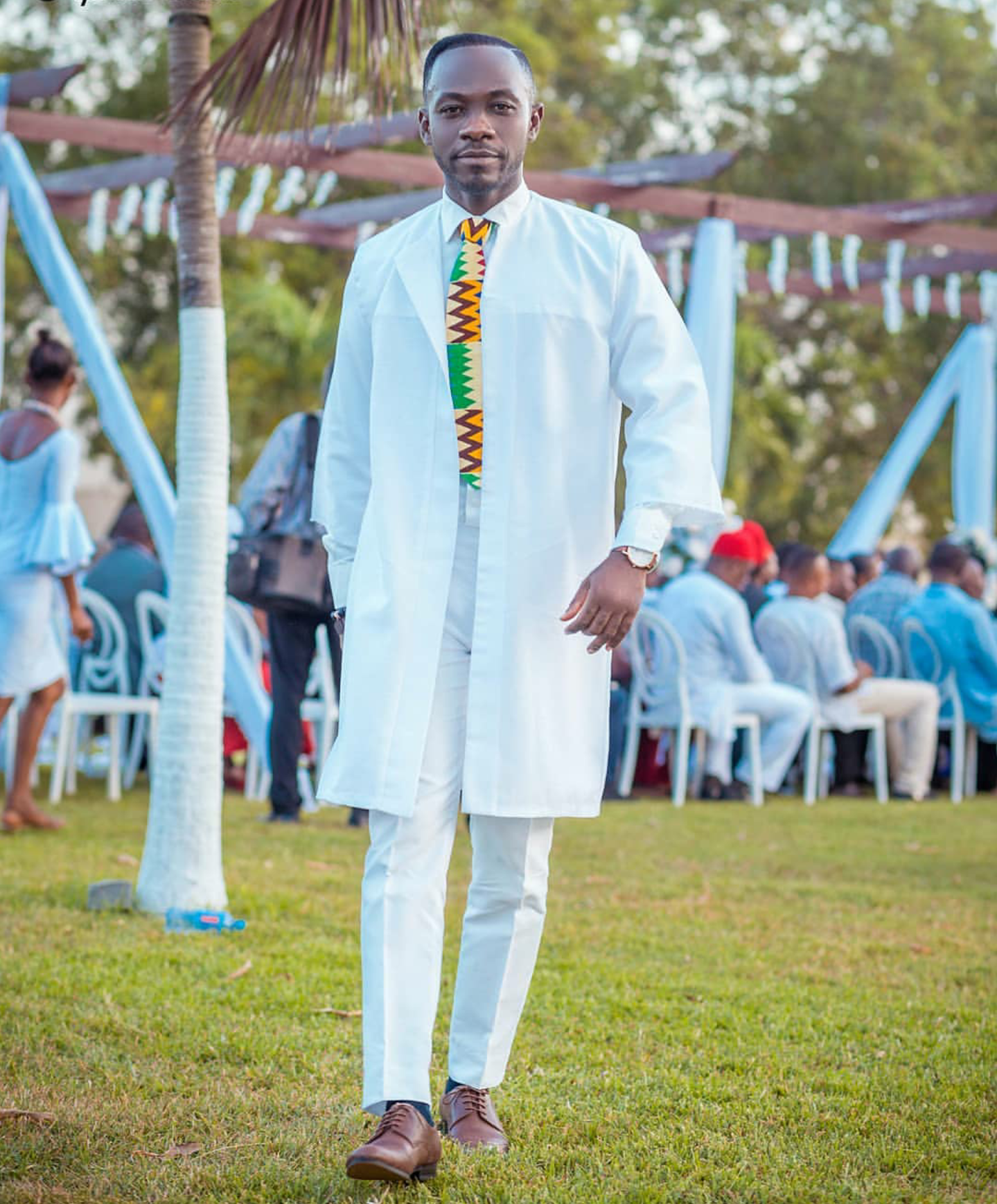 Okyeame served all white perfect matching it with a kente tie