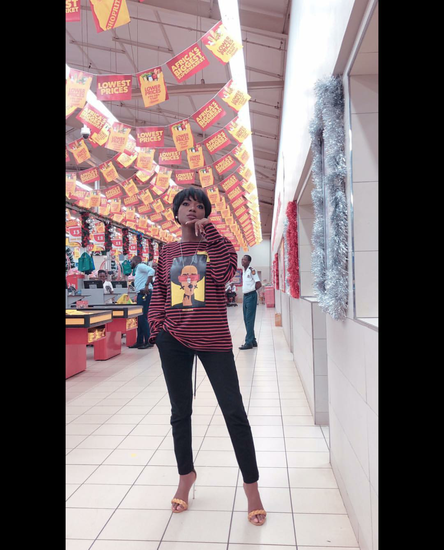 Efya served casual looks in this oversized stripped shirt over pants and heels